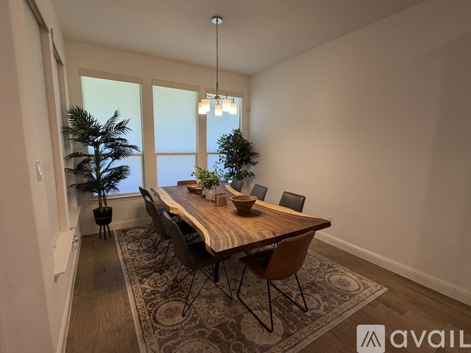 A dining room with a wooden table and chairs.