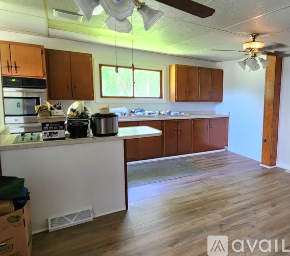 A kitchen with wooden cabinets and a white island.