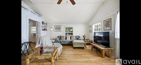 A living room with a television and a couch.