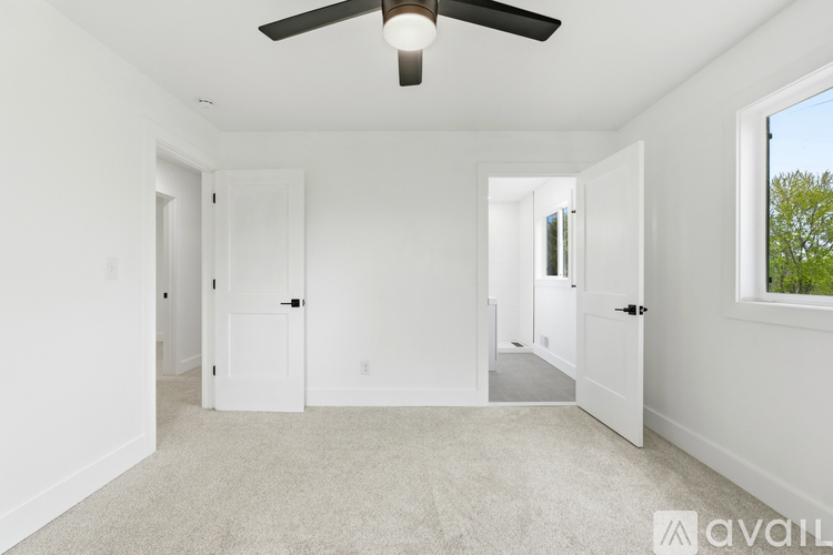 A spacious room with a ceiling fan and a window.