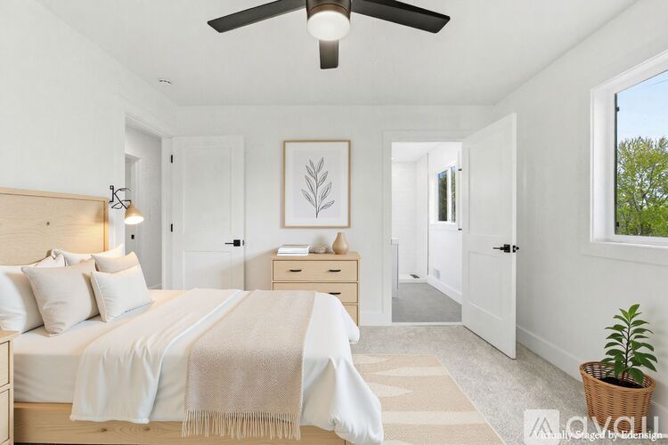 A bedroom with a bed, a ceiling fan, and a window.