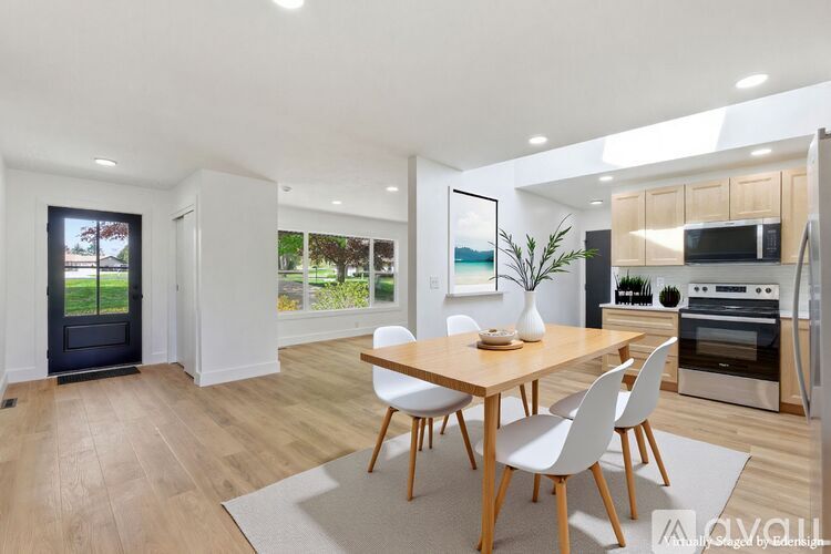 A modern kitchen with a dining table and chairs.