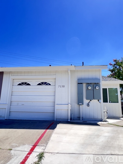 A white garage with the number 7130 on it.