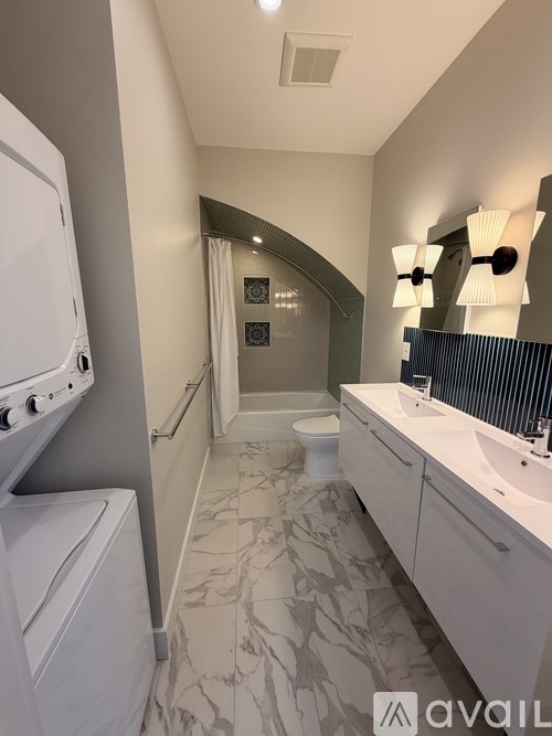 A bathroom with a marble floor and a white oven.