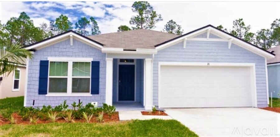A blue house with a white garage door.