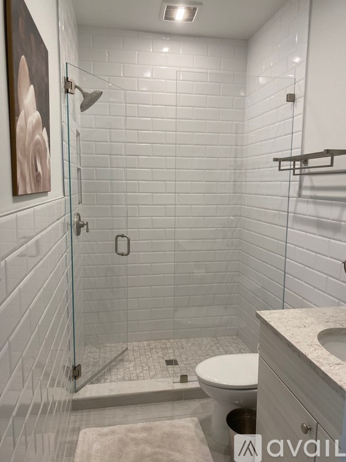 A bathroom with a toilet, sink, and shower.