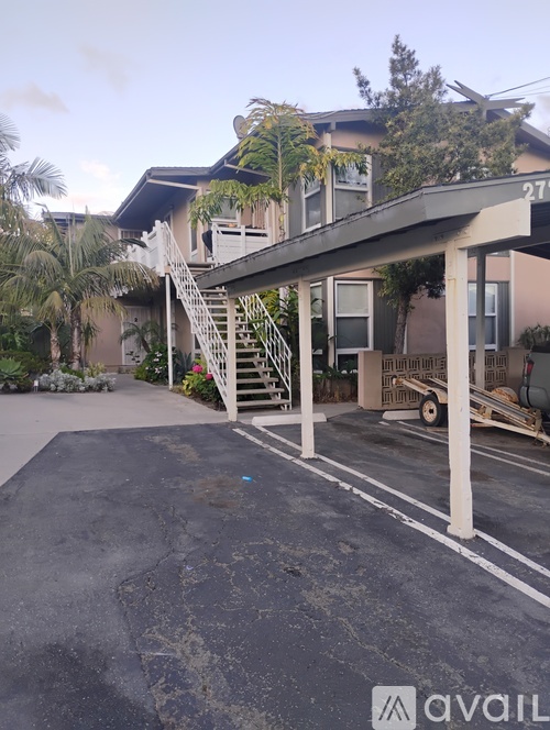 A house number 27 with a driveway and a staircase leading to the front door.