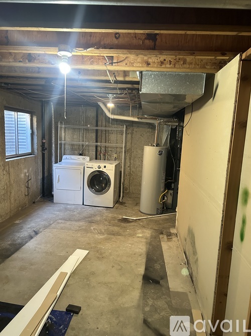 A room with a washing machine and a dryer in it.