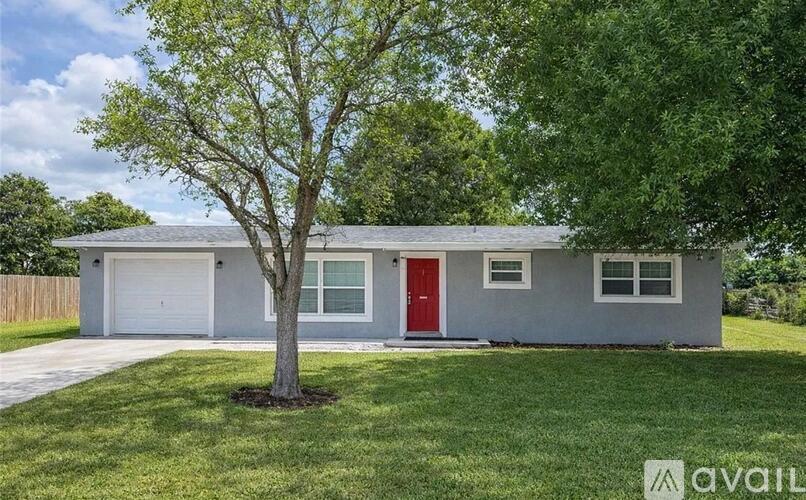 A house with a red door is for sale.