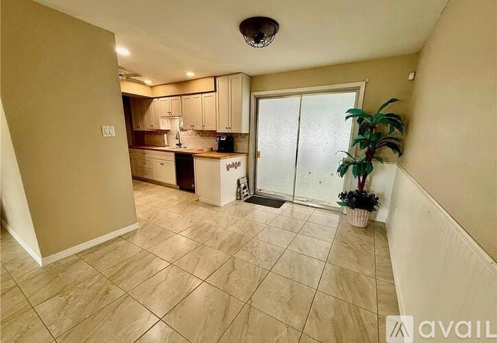 A kitchen area with a dining table and chairs.