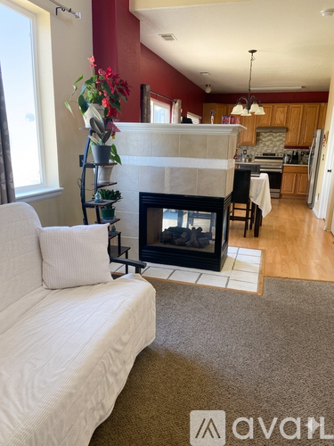 A living room with a fireplace and a white couch.