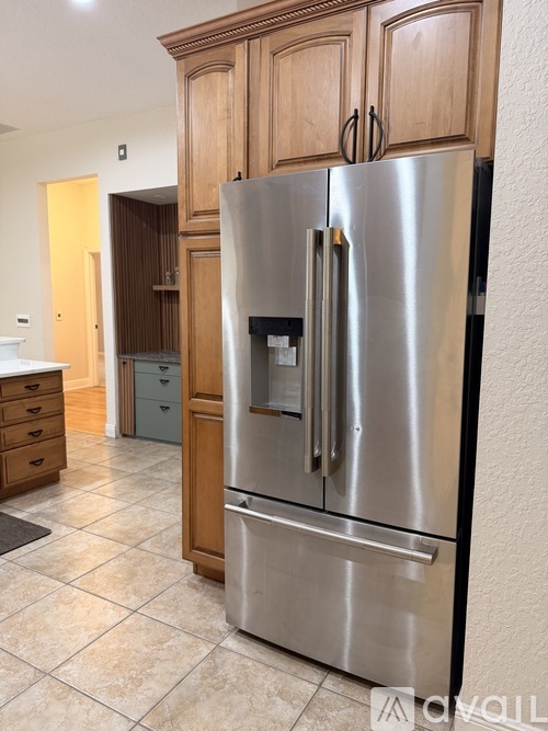 A modern kitchen with wooden cabinets and stainless steel appliances.