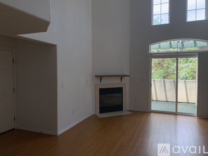 A living room with a fireplace and sliding glass doors.