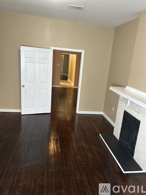 A room with a fireplace and a door.