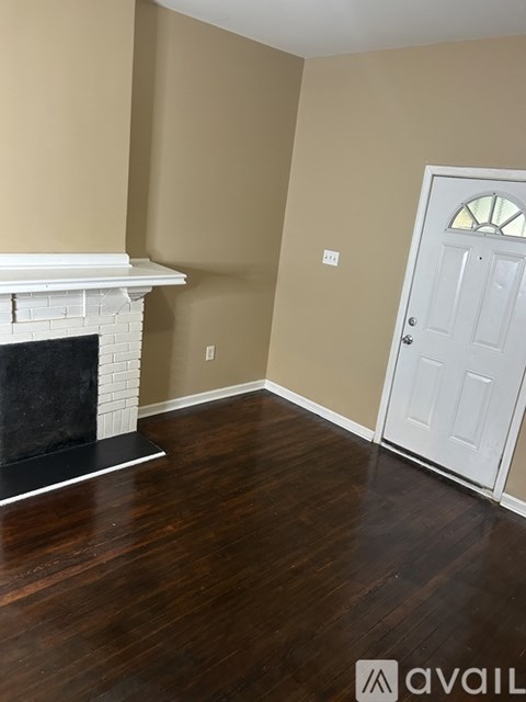 A room with a fireplace and a door.