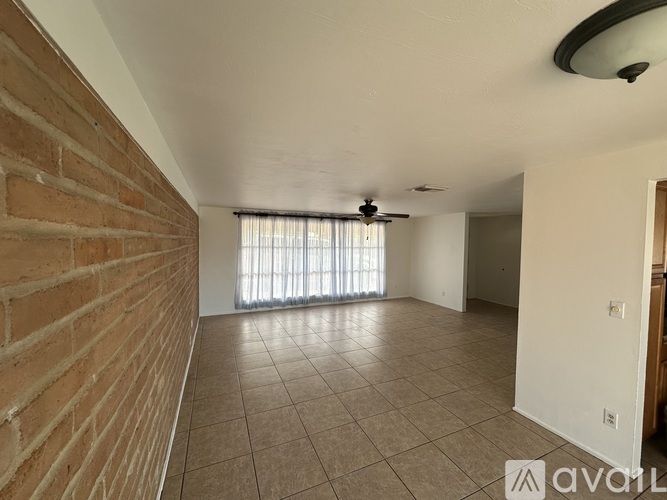 A room with a brick wall and tiled floor.