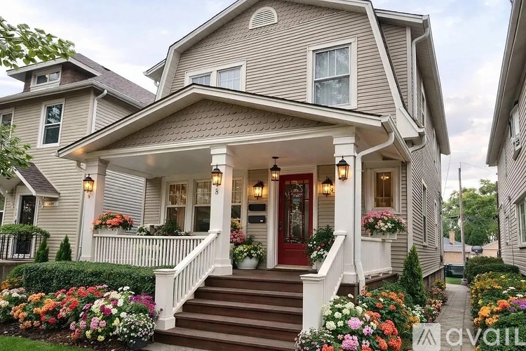 A house with a red door and a front porch with lights.