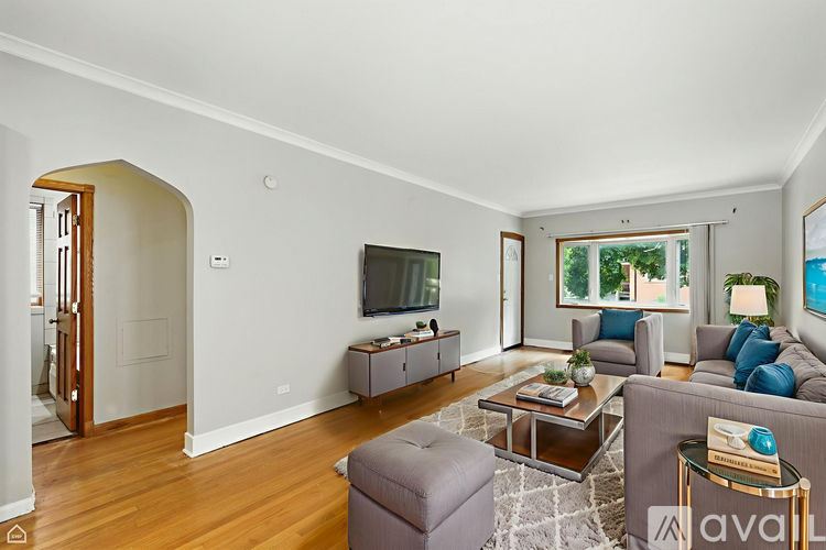 A living room with a grey couch and a coffee table.