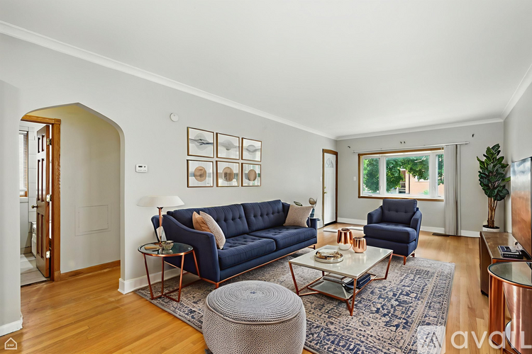 A living room with a blue couch and a coffee table.