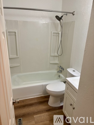 A bathroom with a white toilet, sink, and bathtub.