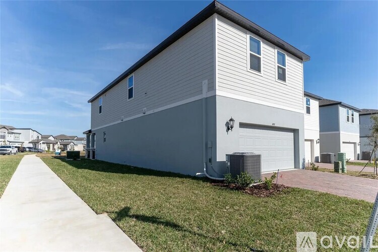 A modern two-story house with a garage and a driveway.
