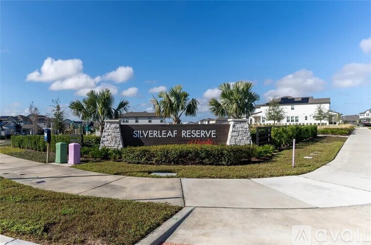 The image shows the entrance to the Silverleaf Reserve of Health with a sign and some greenery.