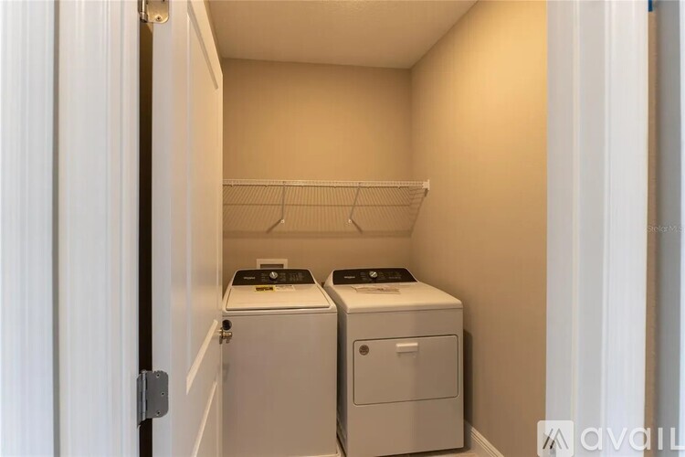 A small laundry room with a washer and dryer.