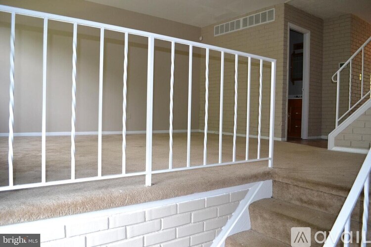 A white railing on a staircase.