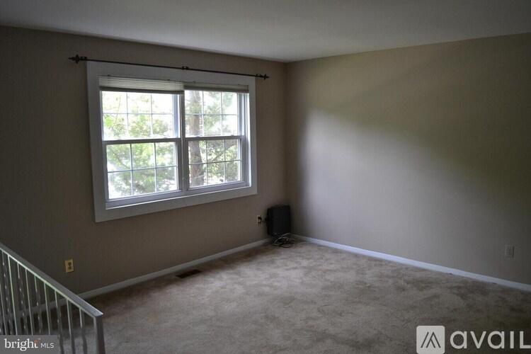 A room with a window and a speaker on the floor.