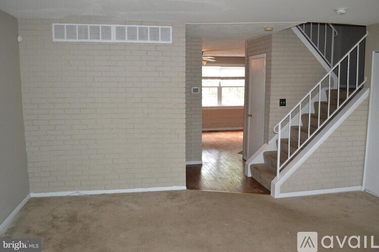 A room with a staircase and a window.