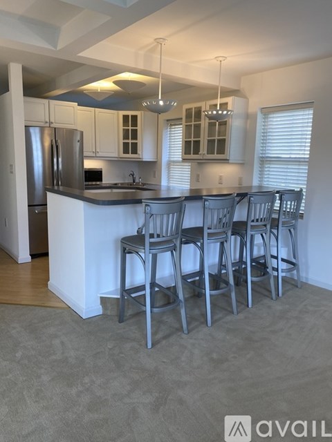 A kitchen with a bar area and four chairs.