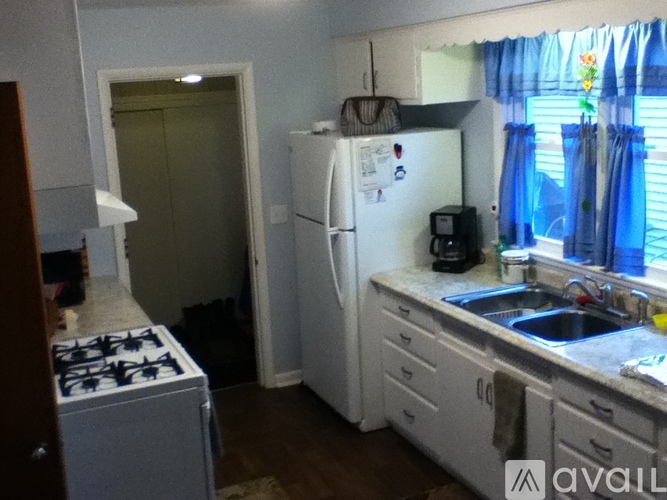 A kitchen with a white fridge and a white stove.