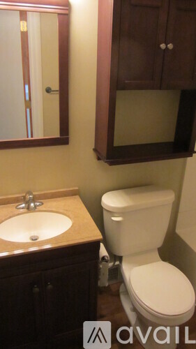 A white toilet sits next to a sink in a bathroom.
