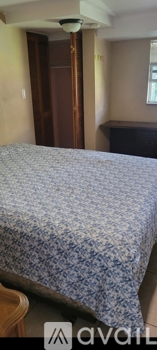 A bedroom with a bed and a wardrobe.