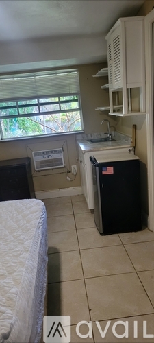 A kitchen with a sink and a fridge.