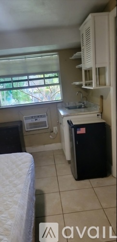 A kitchen area with a sink and a window.