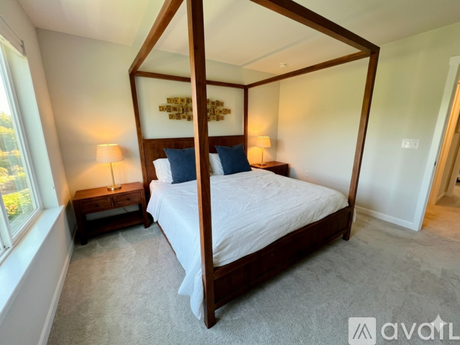 A bedroom with a four poster bed and a window.
