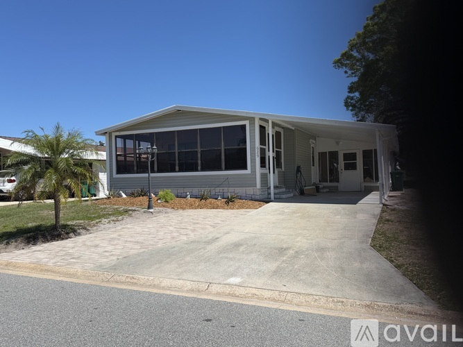 A house with a white exterior and a grey roof is available for rent.