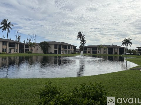 A row of houses with a fountain in the foreground.