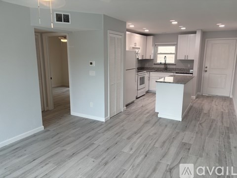 A kitchen with a white island in the middle of the room.
