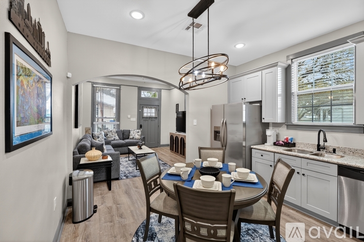A modern kitchen with a dining table set for two.