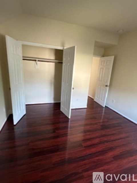 A room with wooden floors and white walls.
