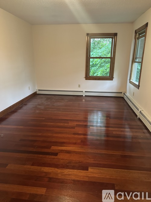 A room with wooden floors and a window.