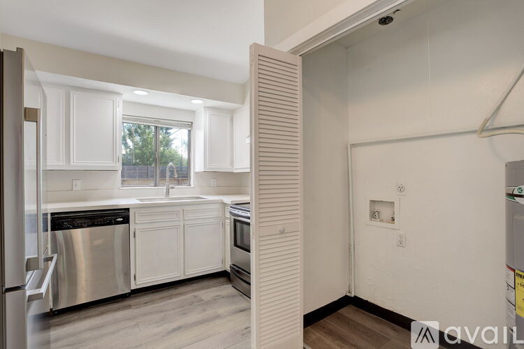 A kitchen with white cabinets and stainless steel appliances.