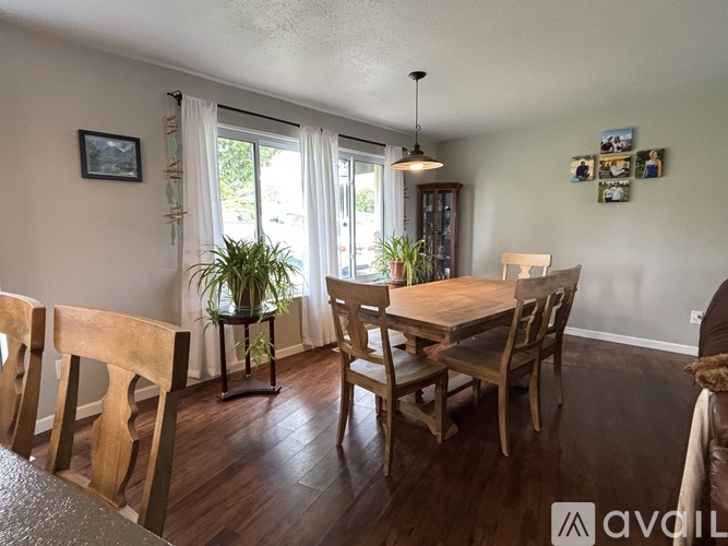 A dining room with wooden chairs and a table.