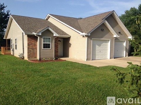 A house with a brown roof and a white garage door.