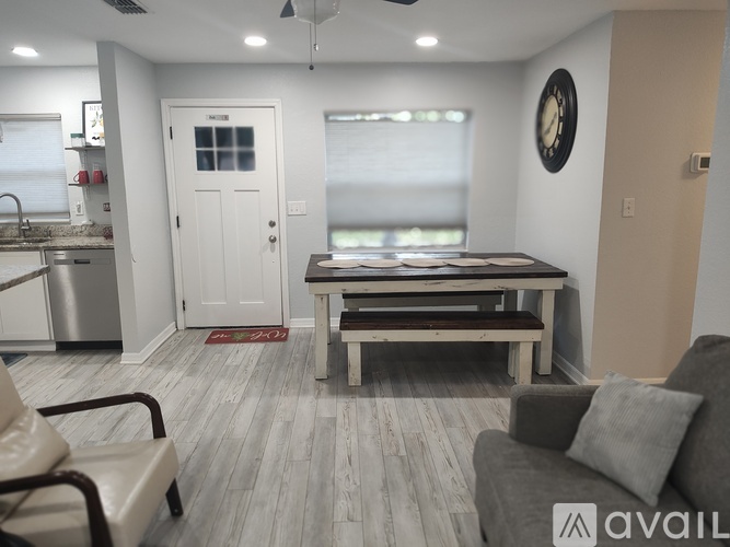 A living room with a grey couch and a wooden table.