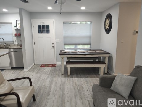 A living room with a grey couch and a wooden table.