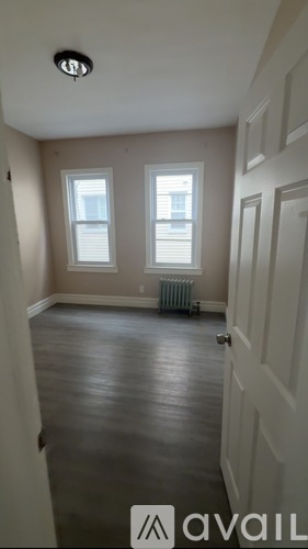 A room with a wooden floor and a white door.