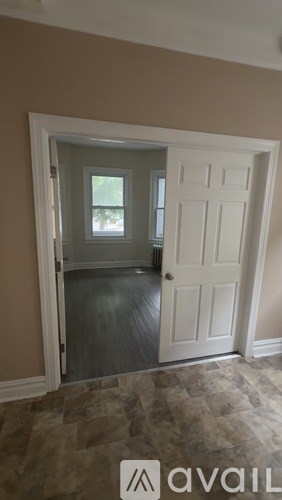 A room with a white door and a window.